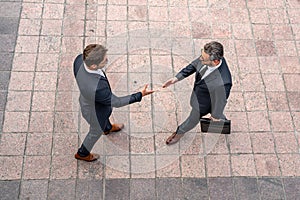 Business man shaking hands. Two businessmen handshake outdoor. Handshake business people. Businessmen communicating at