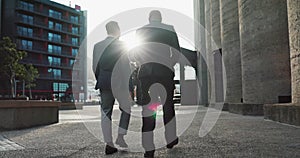 Business, men and walking in city with discussion for morning travel, partnership and rear view with lens flare