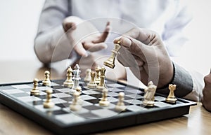Business men and women analyze chess playing strategies to reduce risks and achieve success