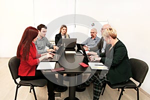 Business men and women at the meeting. Corporate group. Full concentration at work. Group of business people working.