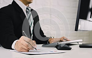 Business men work on the table Analyze graphs financial report in documents and computers