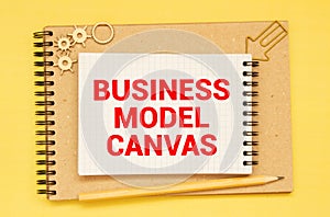 Business Model Canvas. Paper ship and sheet on a gray background