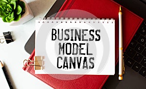 Business Model Canvas. Paper ship and sheet on a gray background