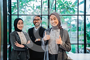 business muslim woman showing thumb up to camera