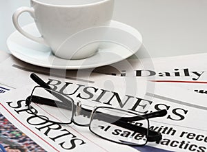 Business newspaper and a cup of coffee