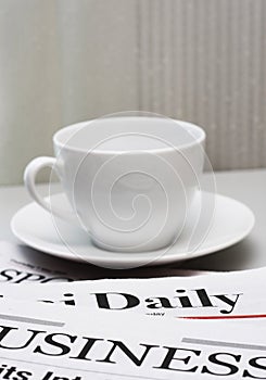 Business newspaper and a cup of coffee