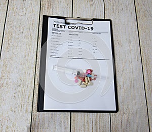 Business notepad holder with covid19 test with syringe photo