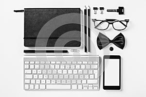 Business objects in order on white desk.
