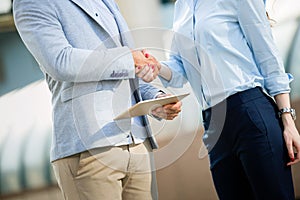 Business and office concept. Businessman and businesswoman shaking hands