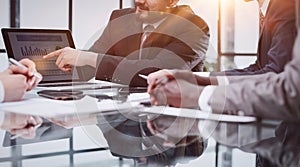 business and office concept - close up of business team with graph on tablet pc screen and coffee in office