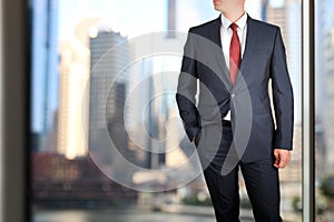 Business and office concept - elegant young fashion buisness man in a blue/navy suit