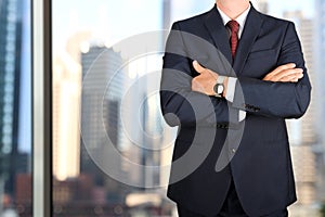 Business and office concept - elegant young fashion buisness man in a blue/navy suit photo