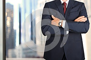 Business and office concept - elegant young fashion buisness man in a blue/navy suit photo