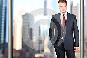 Business and office concept - elegant young fashion buisness man in a blue/navy suit