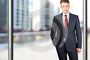 Business and office concept - elegant young fashion buisness man in a blue/navy suit
