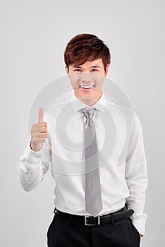 Business and office concept - handsome buisnessman showing thumbs up