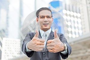 Business and office concept . Young Asia handsome buisnessman showing thumbs up