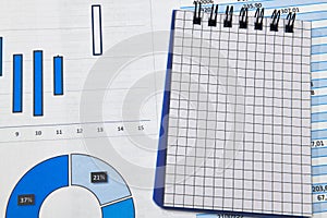 Business office desk closeup - financial reports, analysis and accounting, set of documents, tables and graphs, various items for