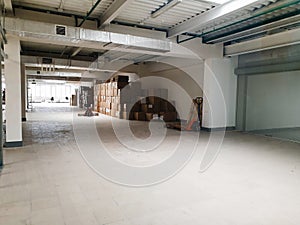 A business or office is moving to a new location. Empty white room with boxes, business is moving to a new space. Renovation and