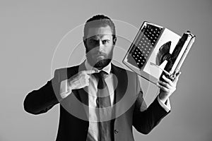 Business in the old manner. business man in blue suit and tie with typewriter