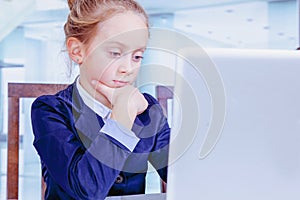 Business, online meetings and web conferencing concept. Humorous image of young cute child business girl conferencing with