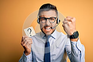 Business operator man with customer service headset from call center showing question mark annoyed and frustrated shouting with