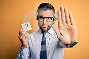 Business operator man with customer service headset from call center showing question mark with open hand doing stop sign with