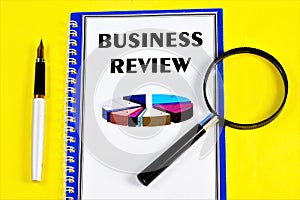 Business overview-text inscription in Notepad and magnifying glass. Look for, plan a strategy to achieve a competitive advantage,