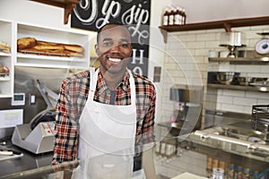 Business owner behind the counter at a sandwich bar