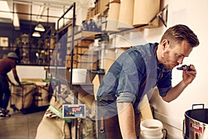 Business owner checking the aroma of freshly roasted coffee bean