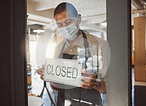 Business owner closing their shop in the pandemic. Boss hanging a closed sign in shop door in quarantine. Small business