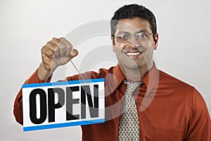 Business owner holding Open Sign