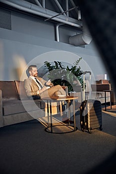 Business owner surfing the Internet on his mobile phone