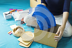 Business owner taking and packing online order to delivery. Freelance woman seller prepare parcel box of product for deliver to