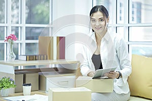 Business owner using tabtet computer confirm and check packing list order, Pack boxes, Shipping parcel package and Delivery