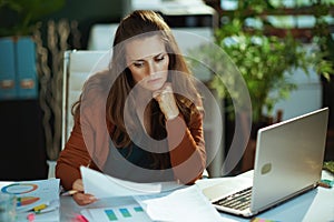 business owner woman in green office working with documents