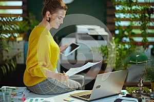 business owner woman in green office working with documents