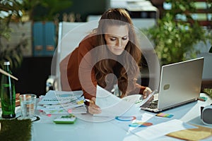 business owner woman in green office working with documents