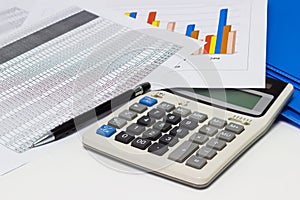 Business paper graphs and pen with charts report, calculator on desk of financial planning