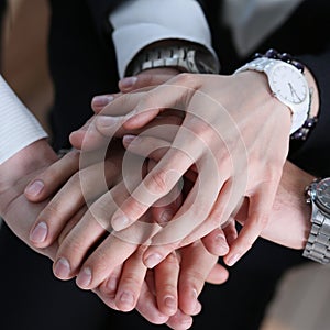 Business partneers putting hands one on one