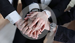 business partneers putting hands one on one