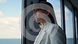Business partner looking window in suit close up. Pensive woman contemplating