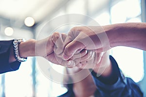 Business partner people joining and stack hand together after contract finished meeting.