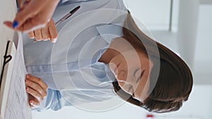 Business partner sign contract deal closeup. Girl checking document vertically