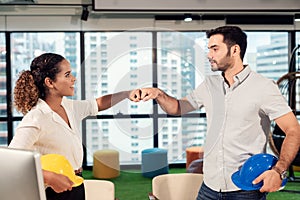 Business partner woman and engineer man joining and stack hand together