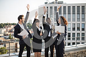 Business partners celebrating successful deal on fresh air