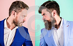 Business partners competitors or office colleagues in suits with tense bearded faces close up. Hostile or argumentative