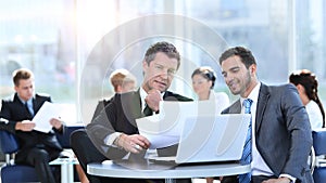 Business partners discuss financial issues sitting in the lobby