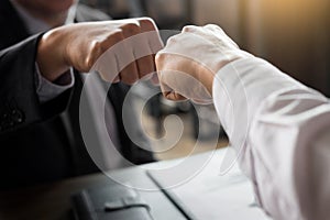 Business Partners Giving Fist Bump to commitment Greeting Start photo