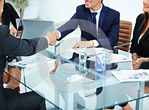 Business partners greet each other with a handshake at the begin